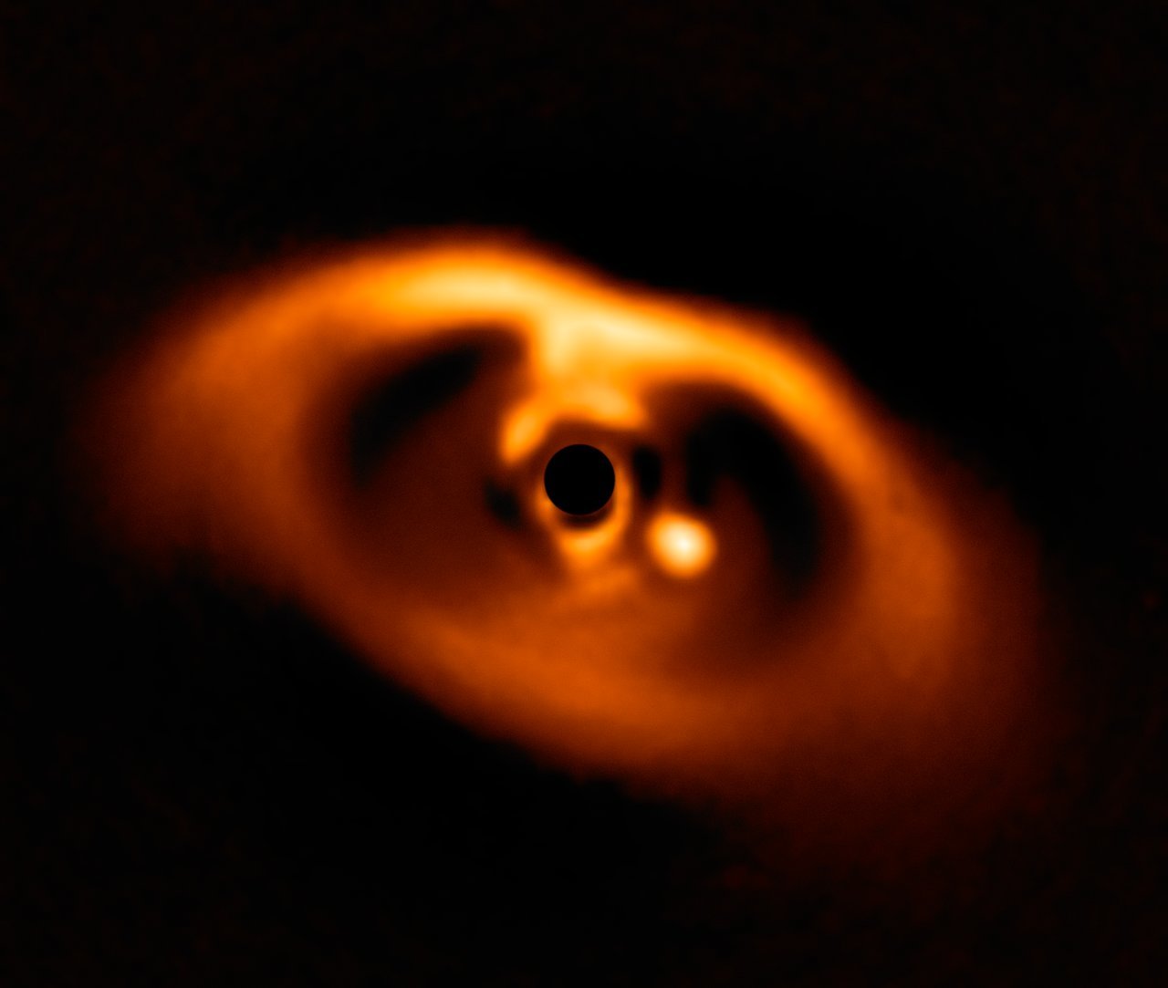 Image of a newborn planet forming around its star.