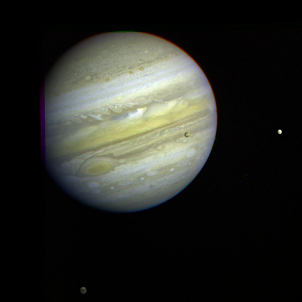 Jupiter, its Great Red Spot and three of its four largest satellites are visible in this photo taken Feb. 5, 1979, by Voyager 1.