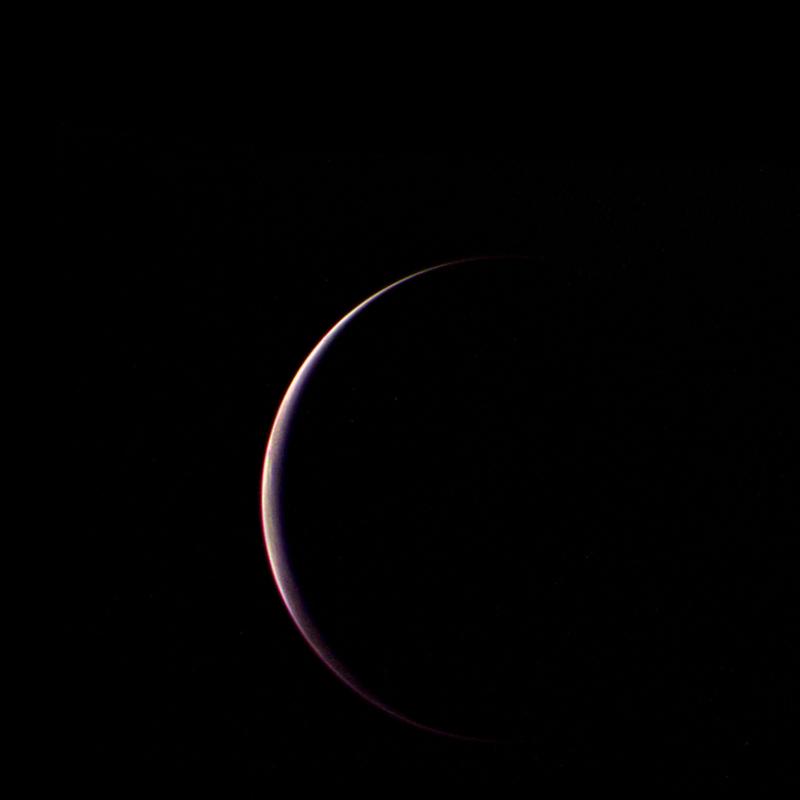 Voyager 2 obtained this parting shot of Triton, Neptune's largest satellite, shortly after closest approach to the moon and passage through its shadow on the morning of Aug. 25, 1989.