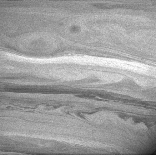 Black and white image of cloud swirls on Saturn