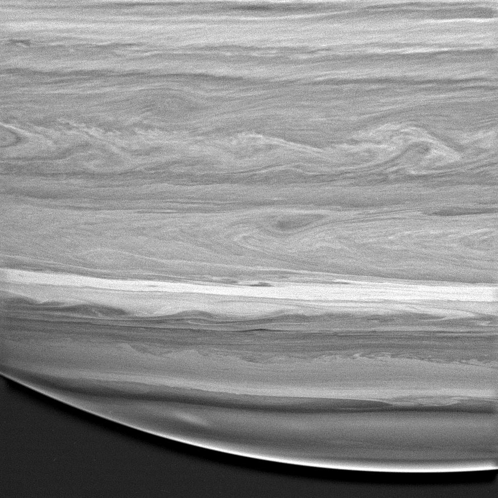 black and white image of saturn showing cloud swirls and details