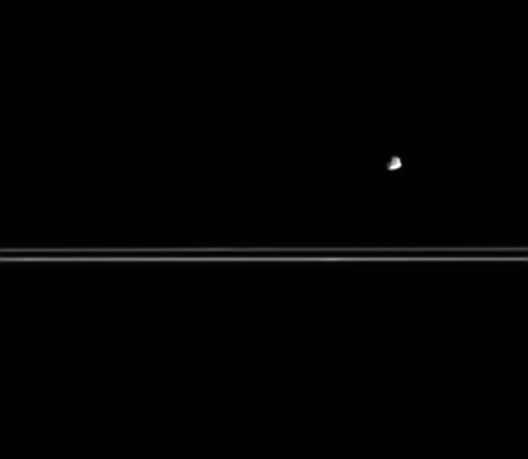 Saturn's moon Epimetheus near a portion of the rings