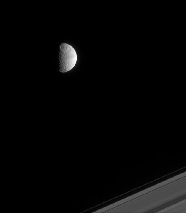 image of the moon Tethys and Saturn's rings