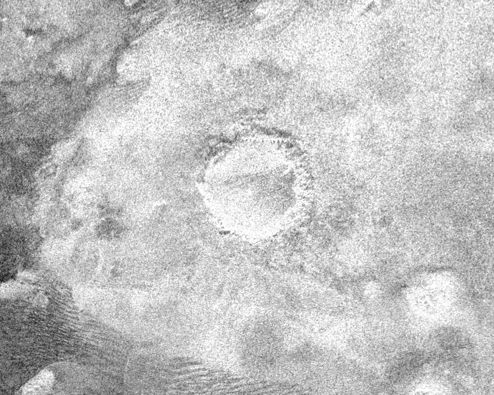 Crater on Titan surrounded by bright blanket of material