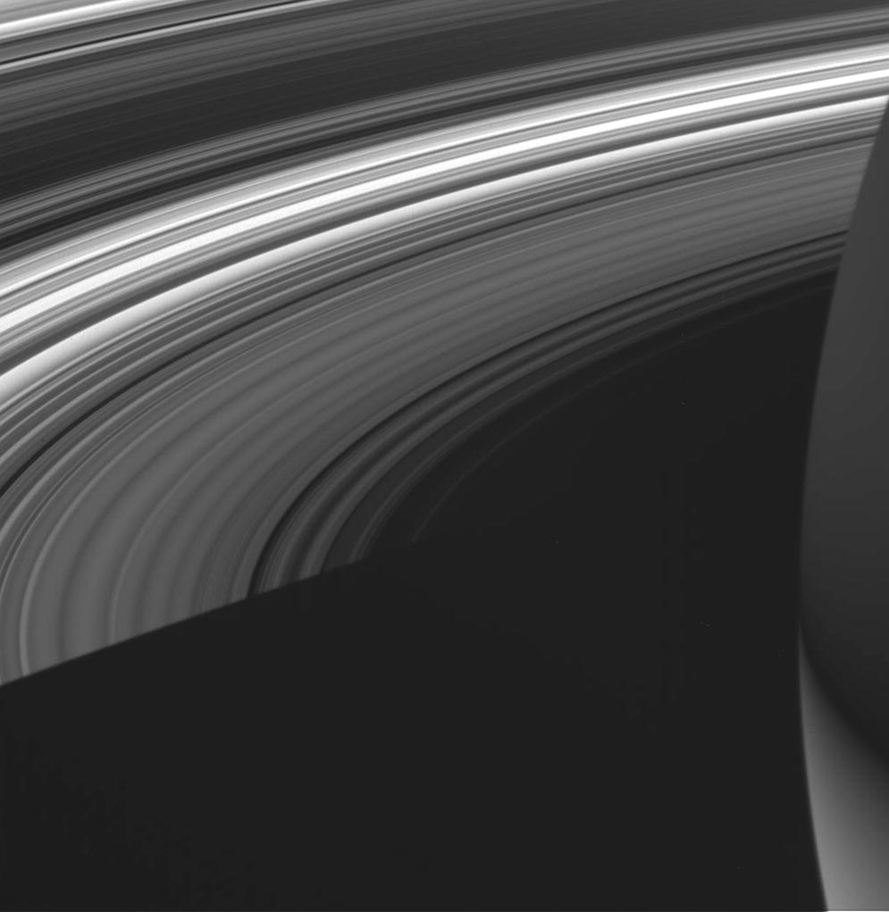 This view shows the unlit side of Saturn's rings made visible by sunlight filtering through the rings from the lit side