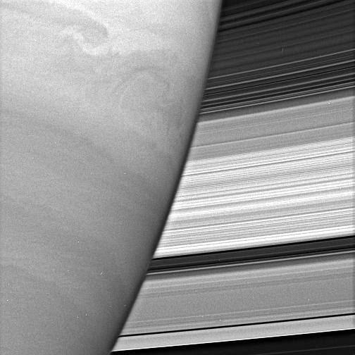 Turbulent swirls churn in Saturn's atmosphere while the planet's rings form a dazzling backdrop