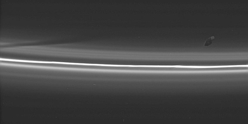 an image of Prometheus with Saturn's F ring in the background