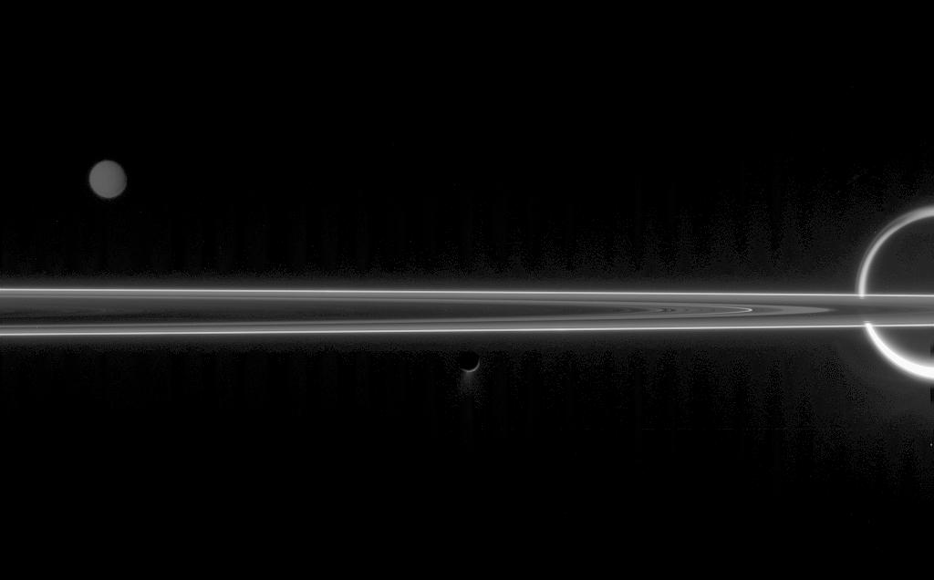 The unlit side of the rings, with Titan, Tethys and Enceladus