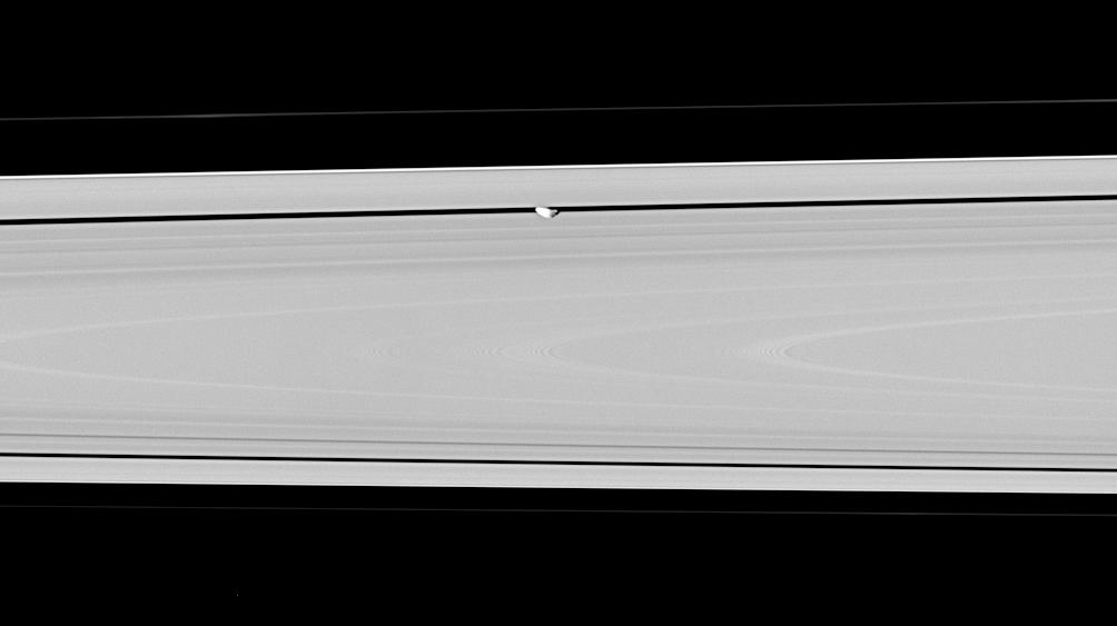 Saturn's moon Pan, partly in shadow and party cut off by the outer A ring