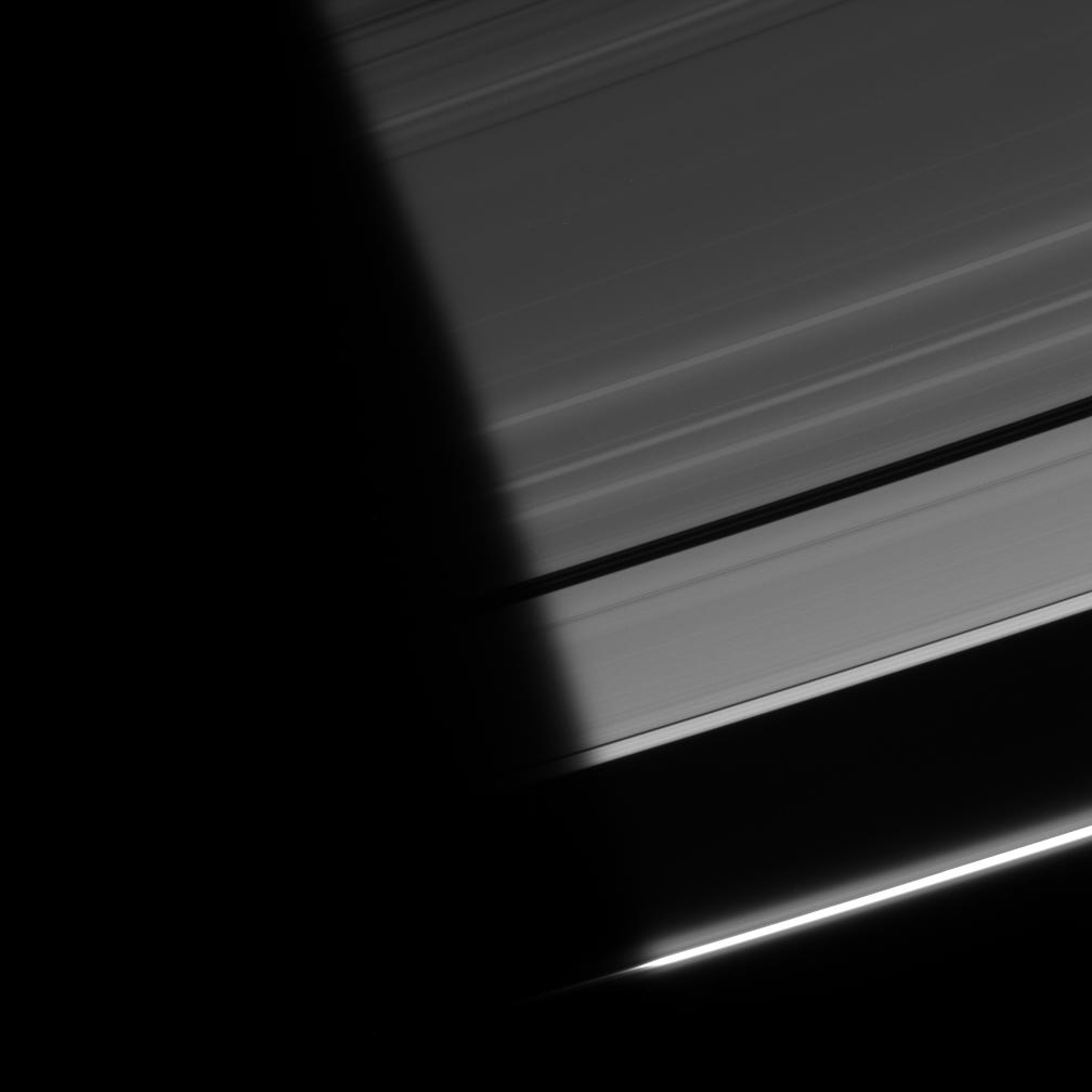 Ring particles emerge from the darkness of Saturn's shadow