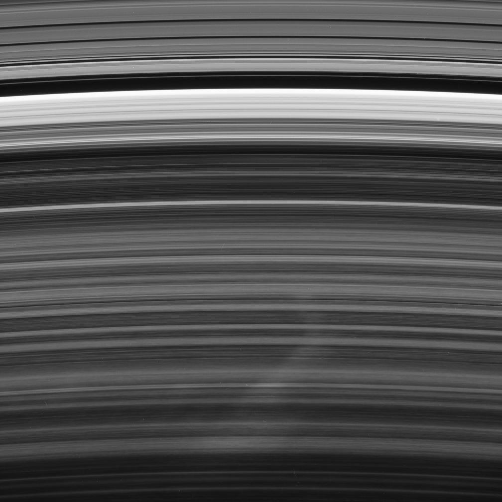A bright spoke extends across the unilluminated side of Saturn's B ring