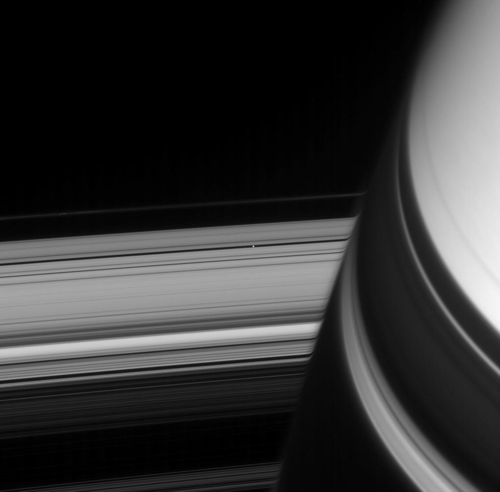 Saturn, it's rings, and the small moon Pan
