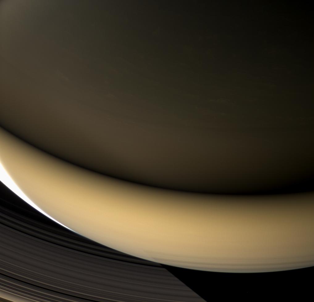 Large regions of Saturn's night side are illuminated by the planet's gleaming rings.