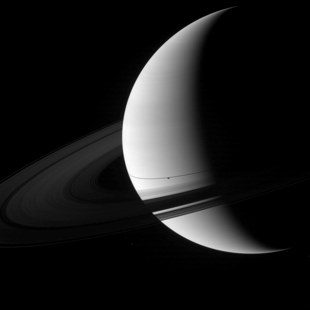 The shadow of the moon Enceladus appears on Saturn