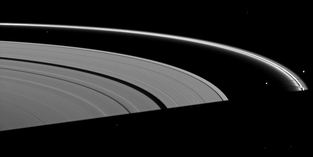 Saturn's moon Prometheus casts a shadow near a streamer-channel created by the moon in the thin F ring in this image taken about a month after the planet's August 2009 equinox.