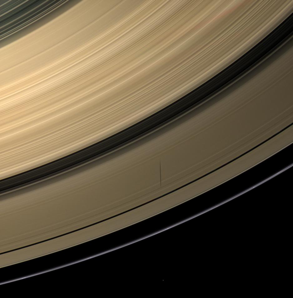 Epimetheus casts a shadow across colorful Saturn's rings