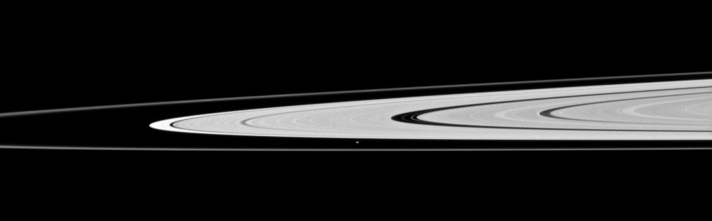 Saturn's moon Atlas, just below the center of this image, orbits in the Roche Division between the A ring and thin F ring.