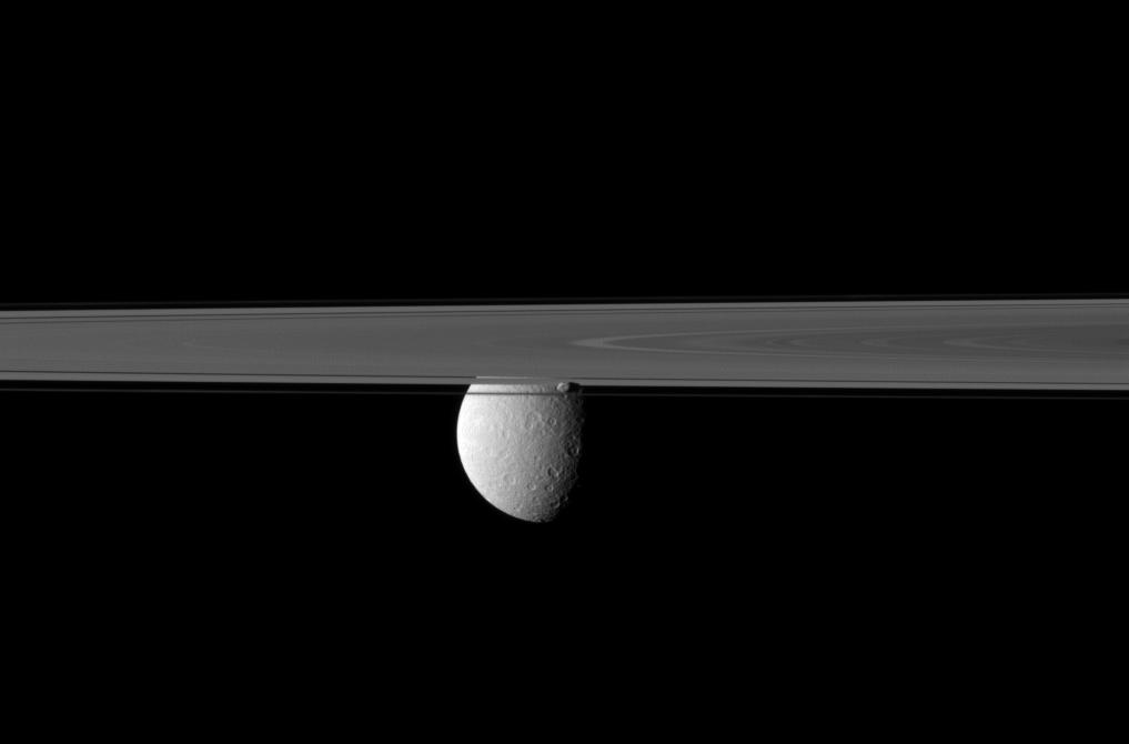 Saturn's rings and Prometheus obscure Cassini's view of Rhea