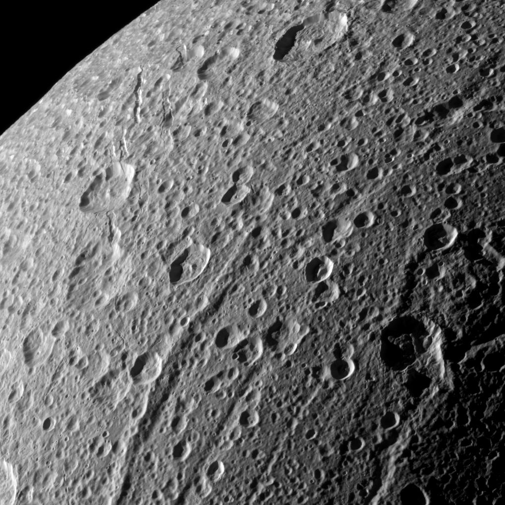 A close-up of the cratered surface of Dione