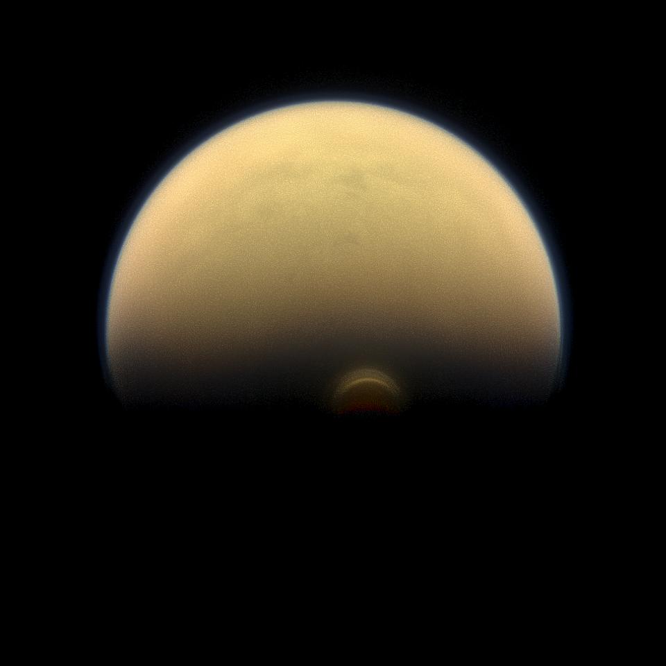 Slipping into shadow, the south polar vortex at Saturn's moon Titan still stands out against the orange and blue haze layers that are characteristic of Titan's atmosphere.
