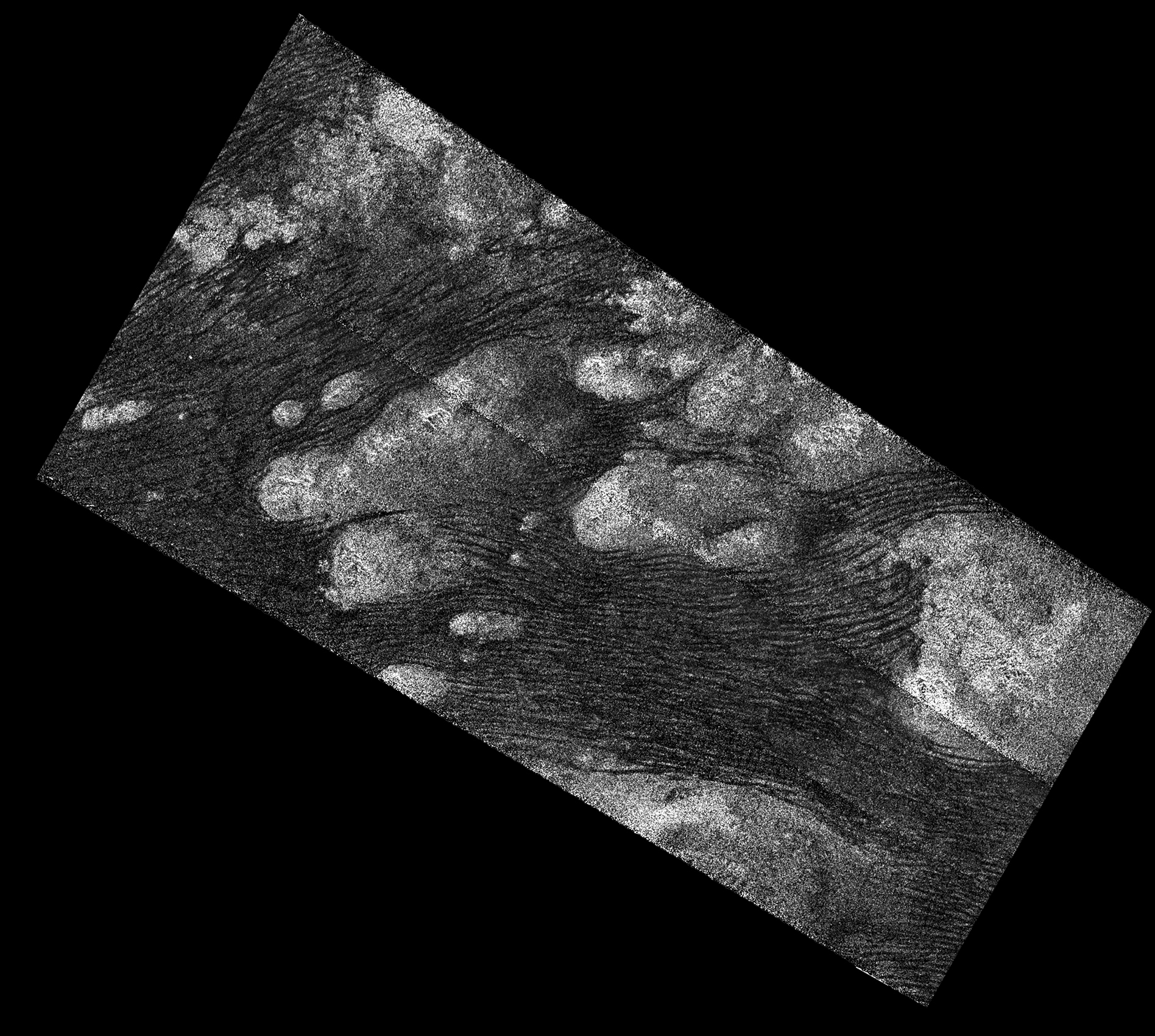 Black and white aerial view of dunes on Titan.