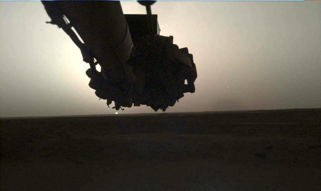 Two images showing the Sun rising and setting on Mars. The Sun is a small orb on the horizon.