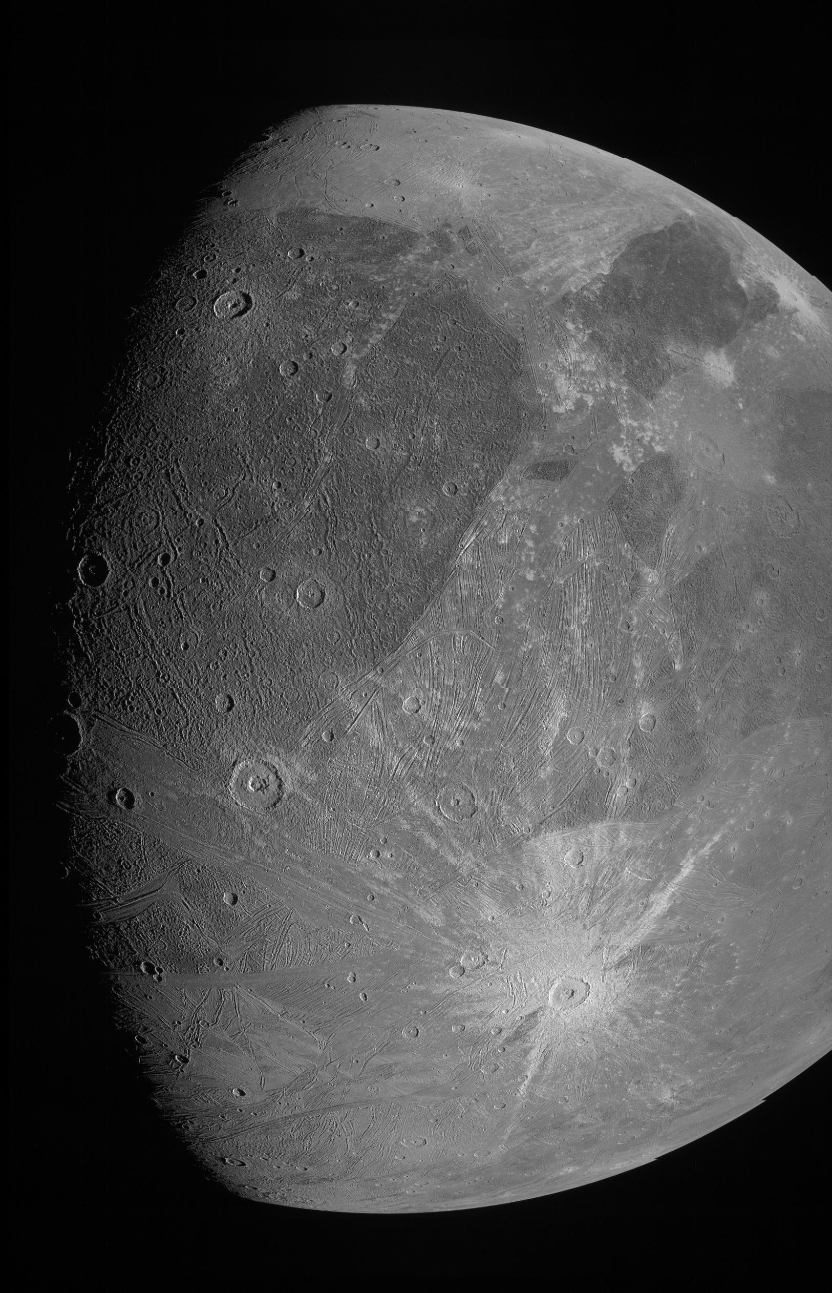 A grayish moon with bright spots and a "belly button" crater at the bottom.