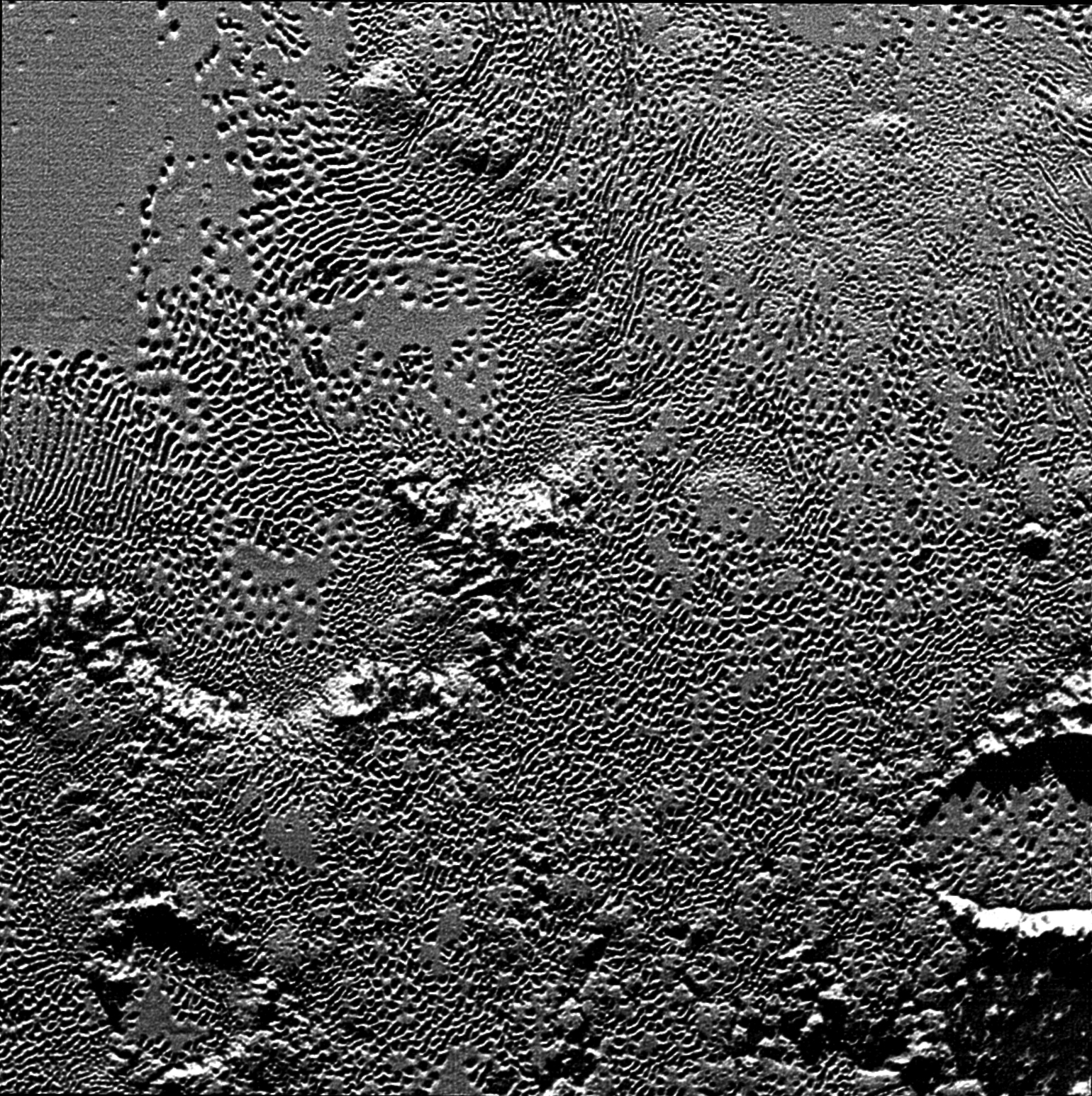 On July 14 the telescopic camera on NASA's New Horizons spacecraft took the highest resolution images ever obtained of the intricate pattern of "pits" across a section of Pluto's prominent heart-shaped region, informally named Tombaugh Regio.