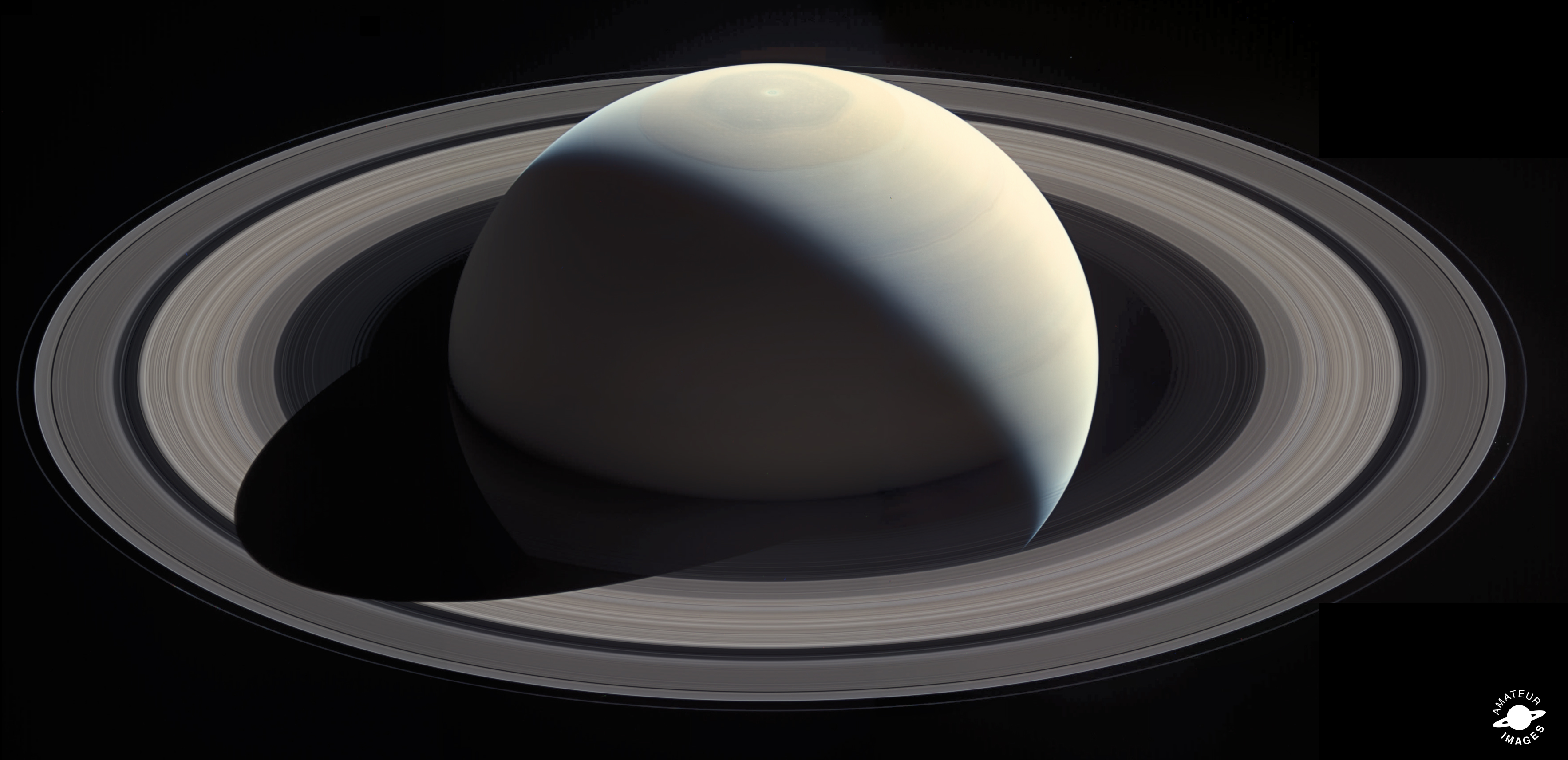 A global view of Saturn showing its yellow-brown structure. Its light-colored rings surround it.