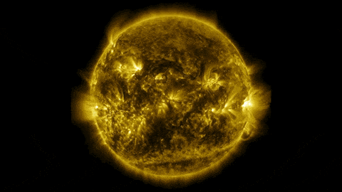 In this GIF, a mottled yellow Sun rotates against a black background. The surface shows activity like flares.