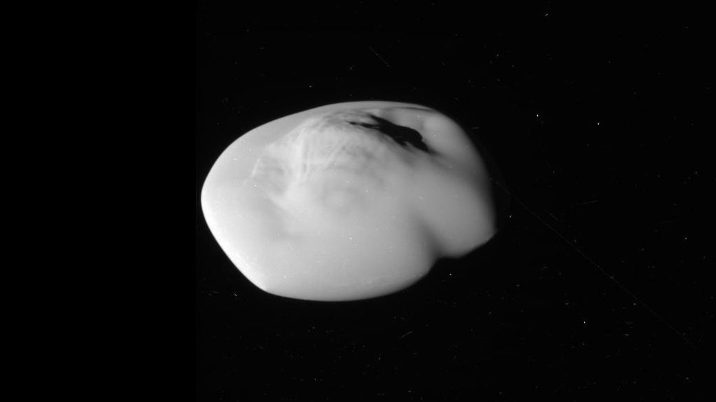 Black and white image of saucer-shaped moon.