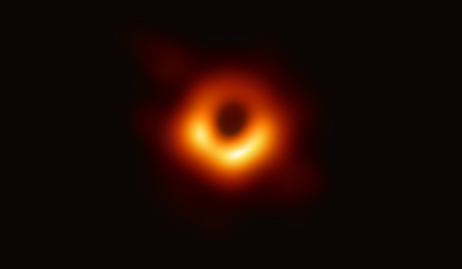 The black hole is outlined by emission from hot gas swirling around it