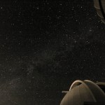 The Milky Way with a telescope in the foreground.