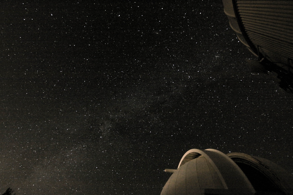 The Milky Way with a telescope in the foreground.