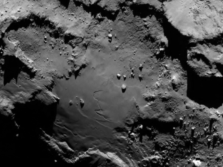 Close up detail focusing on a smooth region on the 'base' of the 'body' section of comet 67P/Churyumov-Gerasimenko.