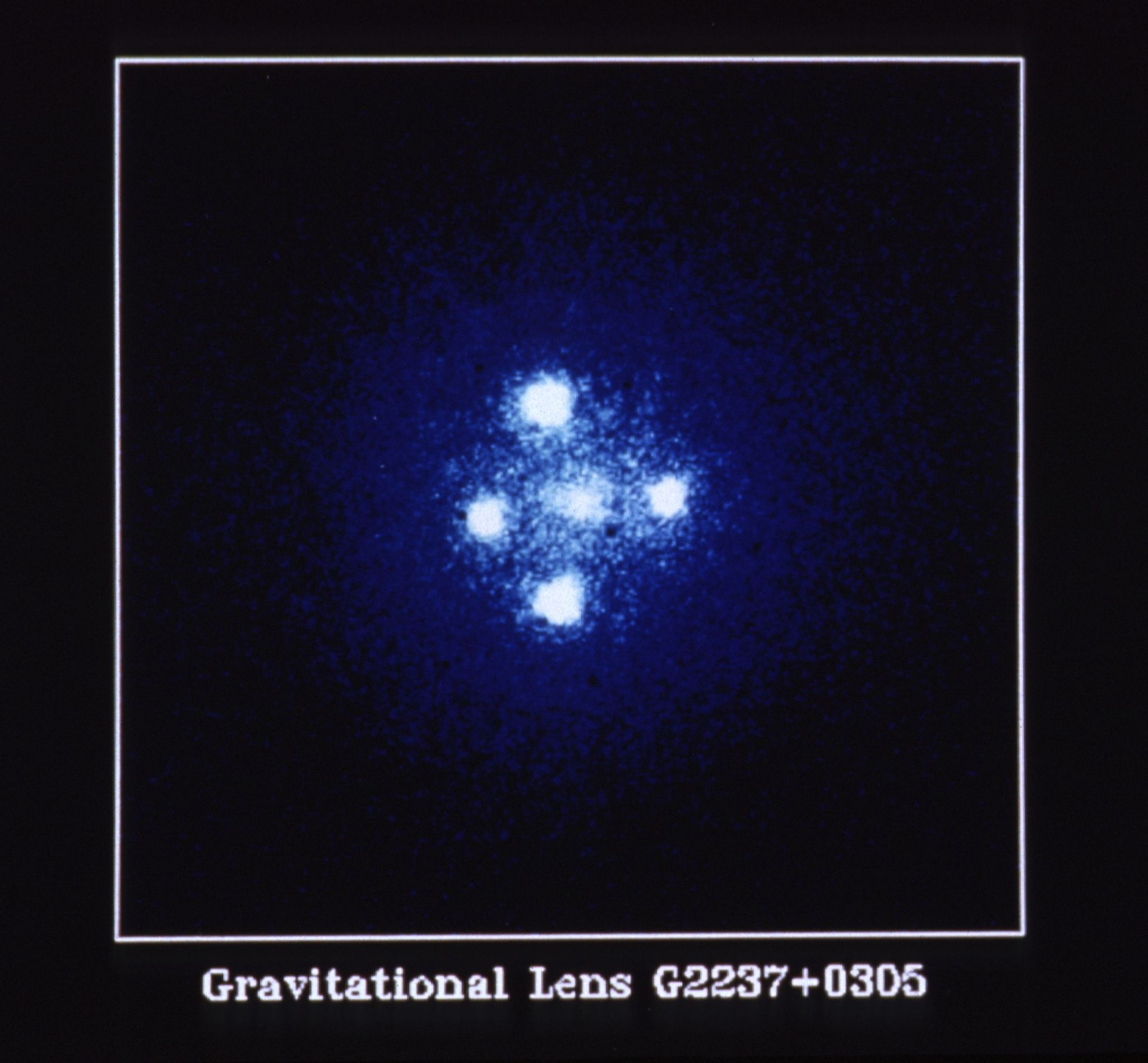 Five bright points of blue-white light. The center point is the galaxy. The four other points are above, below, and left, and right of the center. 