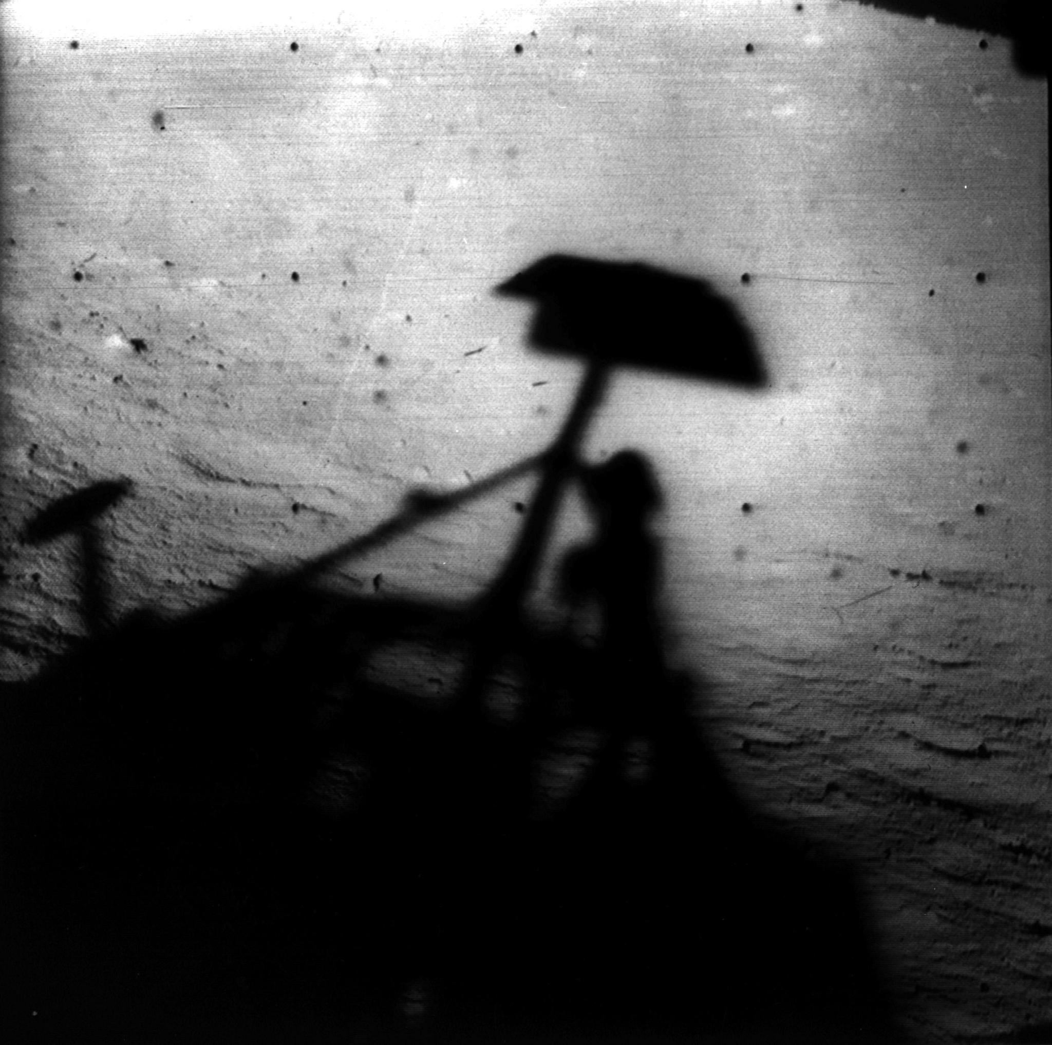 Image of Surveyor 1's shadow against the lunar surface in the late lunar afternoon, with the horizon at the upper right.