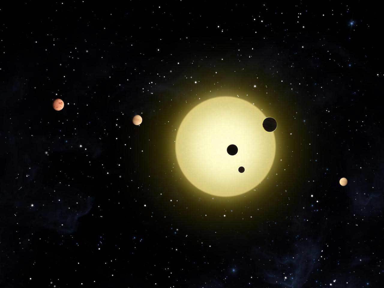 Artist's rendering of six planets orbiting a Sun-like star, Kepler-11. A newly discovered system, also likely with six planets, includes a "super-Earth" and four "mini-Neptunes." Image credit: NASA/Tim Pyle.