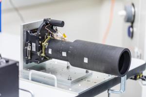 Psyche's dark gray imager sits on a metallic platform.
