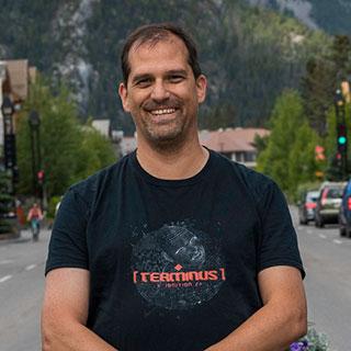 A smiling man standing on the street