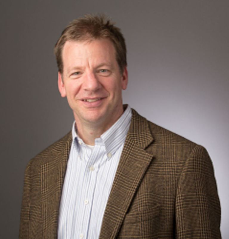 Portrait of Dr. Mark Weislogel in a button-up shirt and blazer.