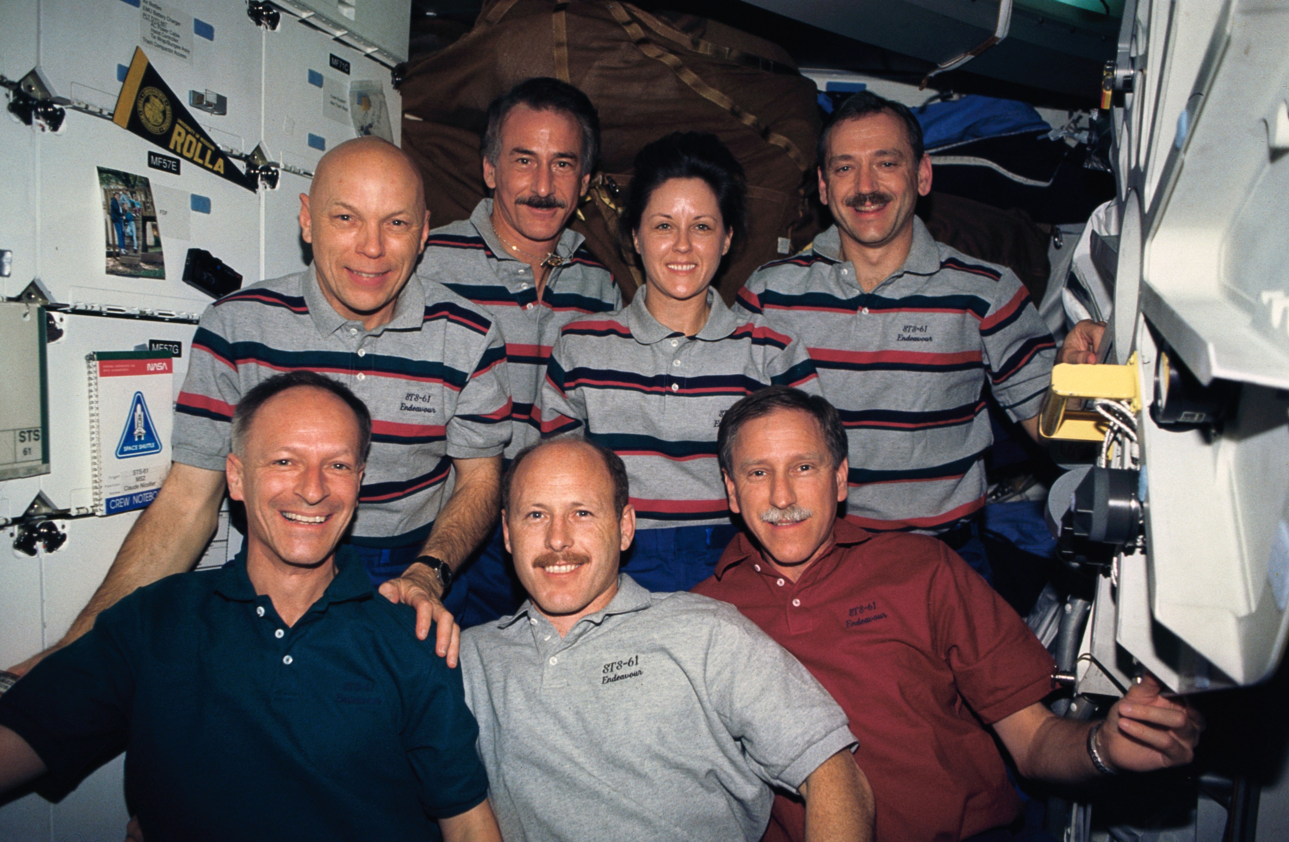 The astronauts of STS-61, the first servicing mission to Hubble, pose for an unofficial portrait while in orbit.