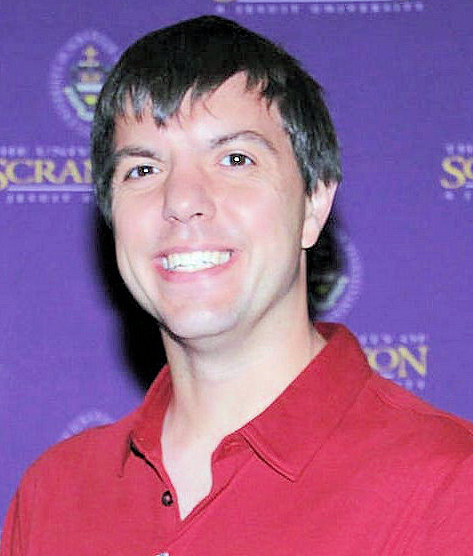 Portrait photo of a man in a red shirt