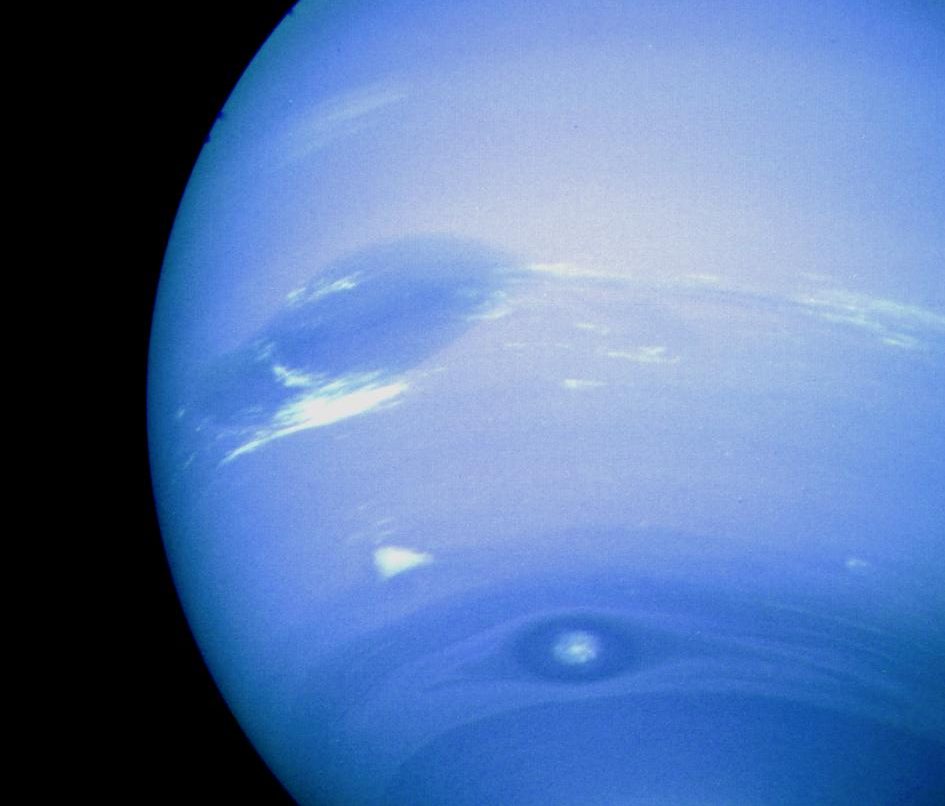 Blue Neptune and its storms as seen from a spacecraft.