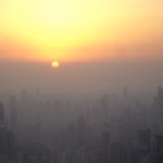 Shanghai at sunset, as seen from the observation deck of the Jin Mao tower. The sun has not actually dropped below the horizon yet, rather it has reached the smog line.