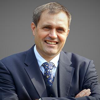 Portrait photo of a man in a suit.