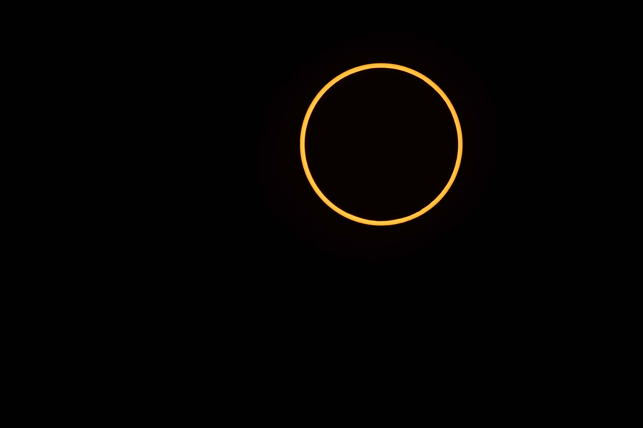 A thin orange circle against a black background