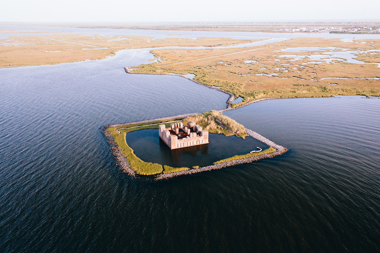 The ruins of a Civil War-era structure, Fort Beauregard, lie partially submerged east of New Orleans. Researchers say many large coastal cities around the world sink faster than sea levels rise. Credit: Frank McMains.