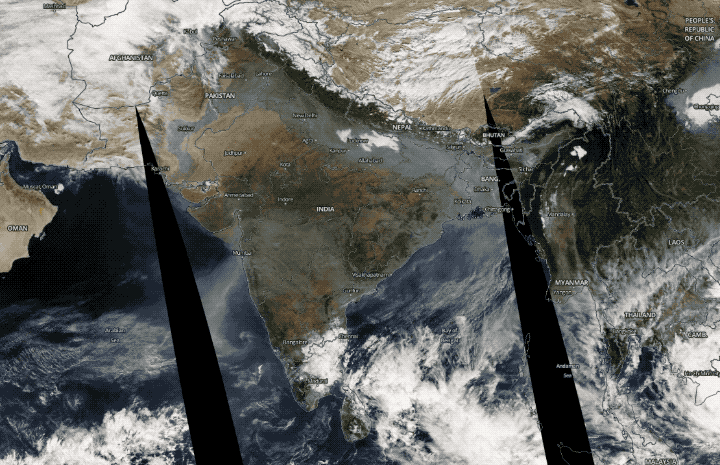 The false color image shows reds, yellows and oranges representing aerosols trapped over India.