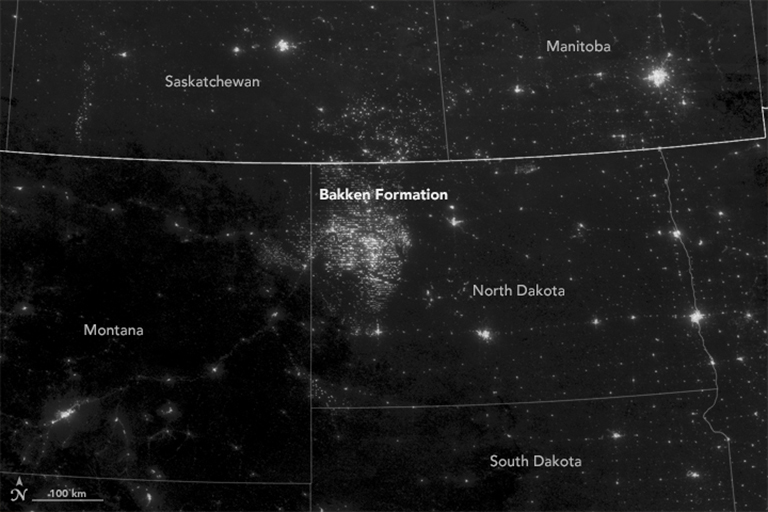 Nightime imagery collected by the Suomi NPP satellite shows light associated with oil extraction activities on the Bakken Formation in the northwest corner of North Dakota. Most of the light seen in the image emanates from electric lights, while gas flaring is responsible for a small fraction of it. Credit: NASA's Earth Observatory.